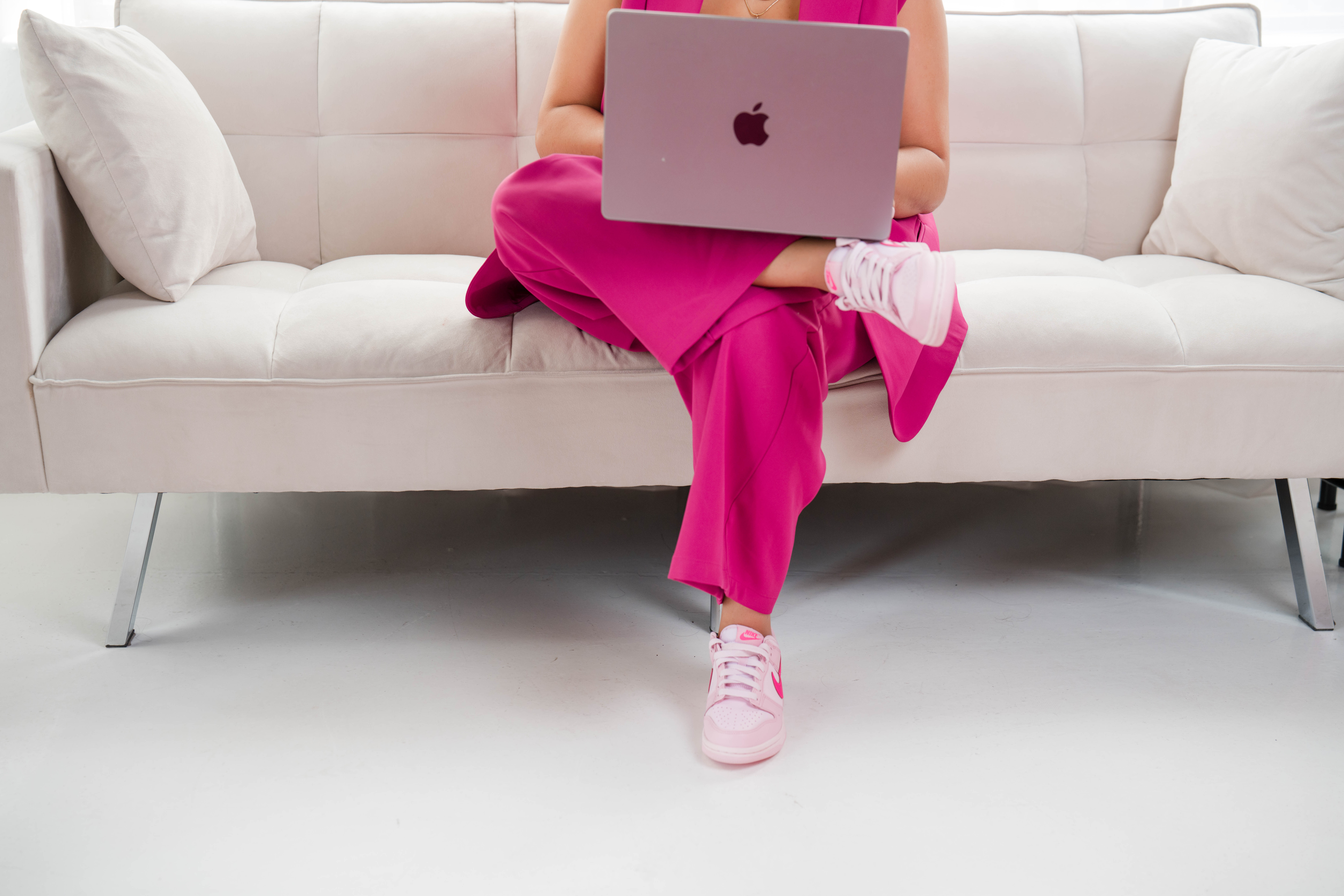 lady's legs on a couch with laptop on lap